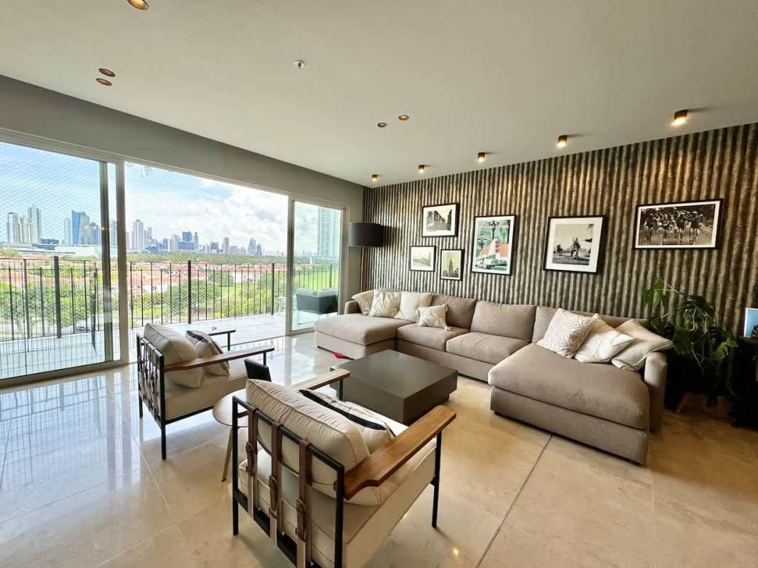 Large covered balcony with glass railing and golf views PH The Reserve Santa María Panama City