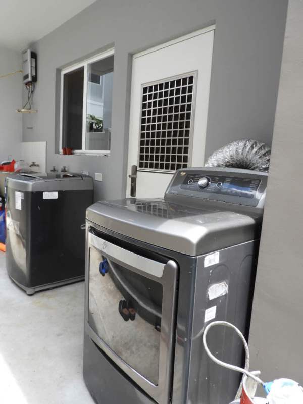 Modern outdoor pool with jacuzzi, cabanas, loungers, landscaping Brisas del Golf Panama