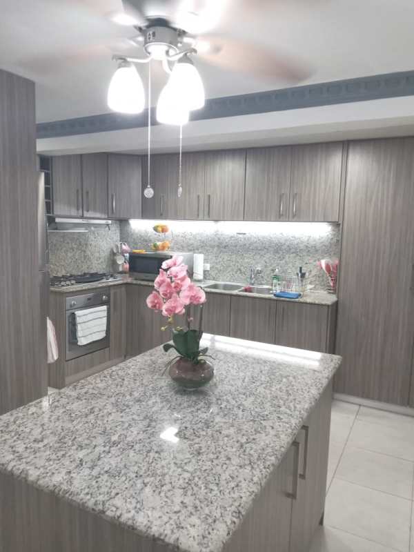 Kitchen with granite countertops, wood cabinets, stainless appliances