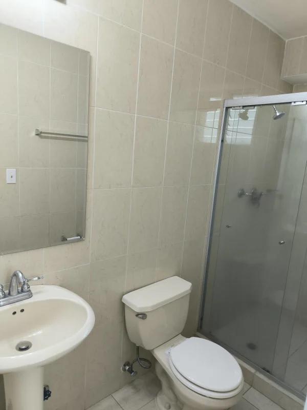 Minimalist bathroom with glass shower, pedestal sink, ceramic tile in PH Majestic Garden Edison Park