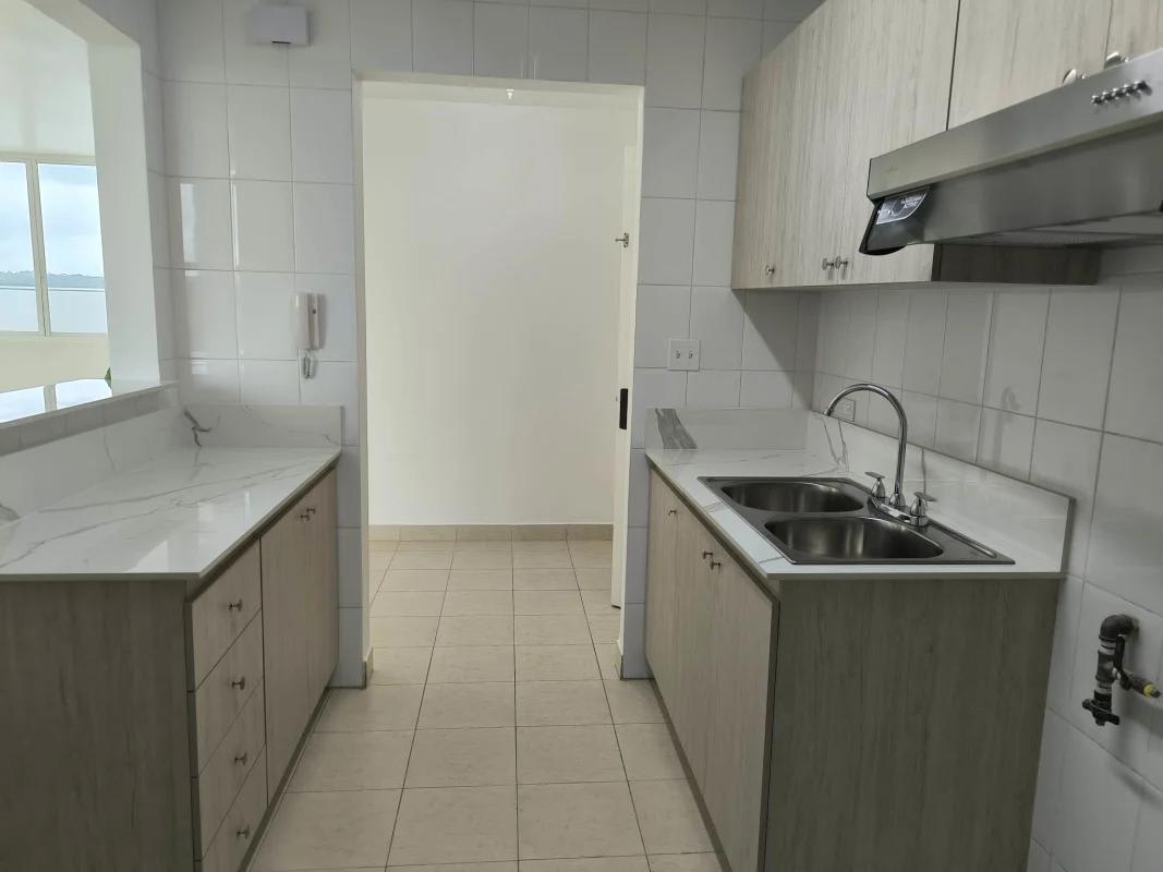 Galley kitchen marble-style counters cabinets PH Majestic Garden Panama City