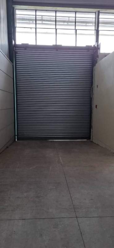 Garage style industrial rolling door with concrete floor Villa Zaita Panama
