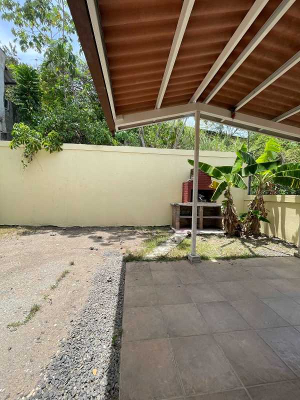 Front of house with gated driveway parking at Brisas del Golf Panama City home for sale