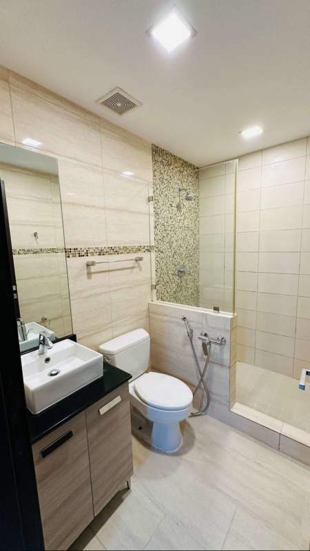 Contemporary bathroom with double sinks, large mirror, glass-enclosed shower at PH Grand Tower Punta Pacifica