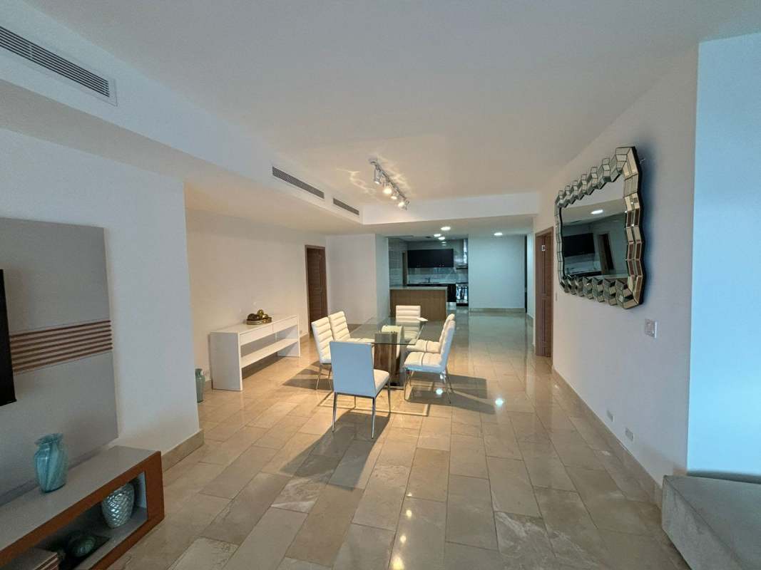 Modern walk-in closet with built-in shelving, drawers at Grand Tower condo Panama