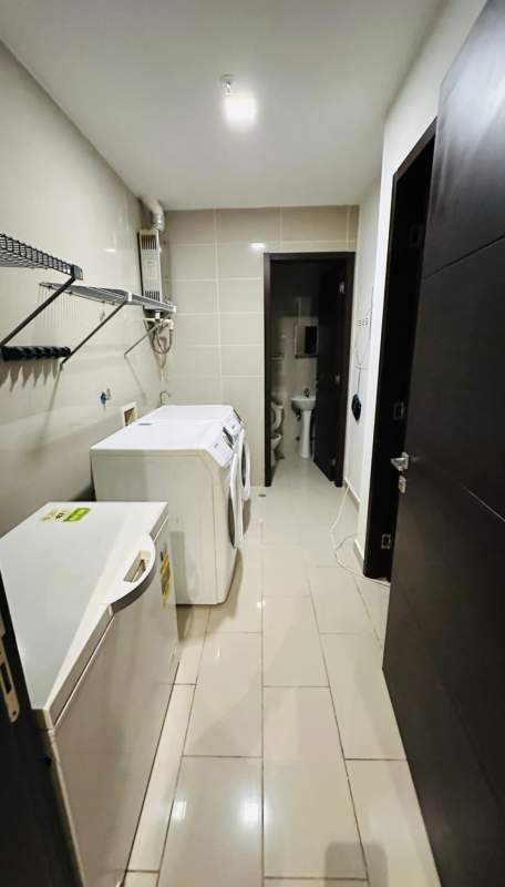 Laundry area with appliances, tiled floors and storage at Grand Tower Punta Pacifica