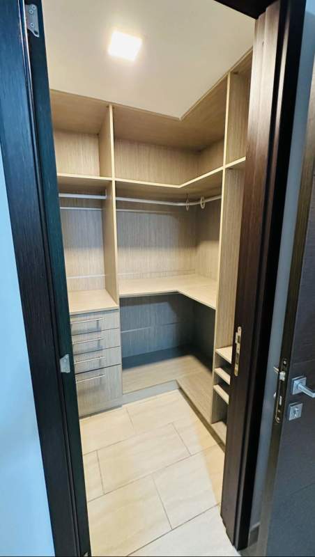 Upscale kitchen with stainless steel appliances, granite counters, dark wood cabinets at Grand Tower Panama City