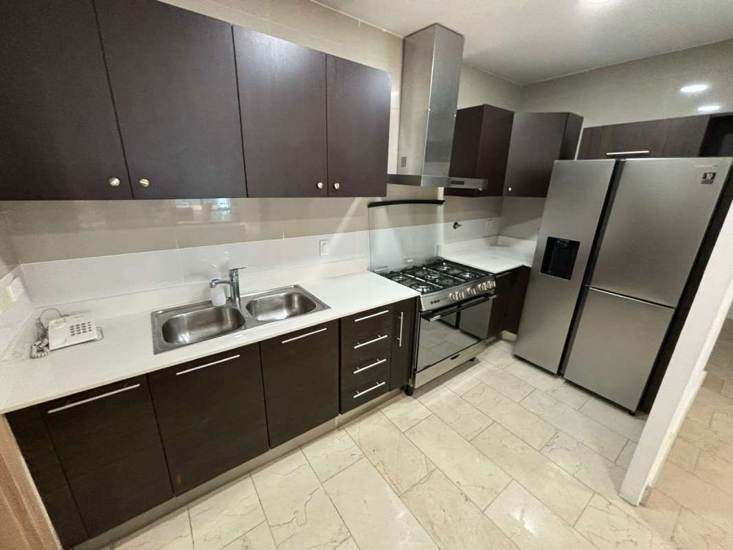 Luxurious bathroom with double sinks, mosaic accents, glass shower at Grand Tower Punta Pacifica