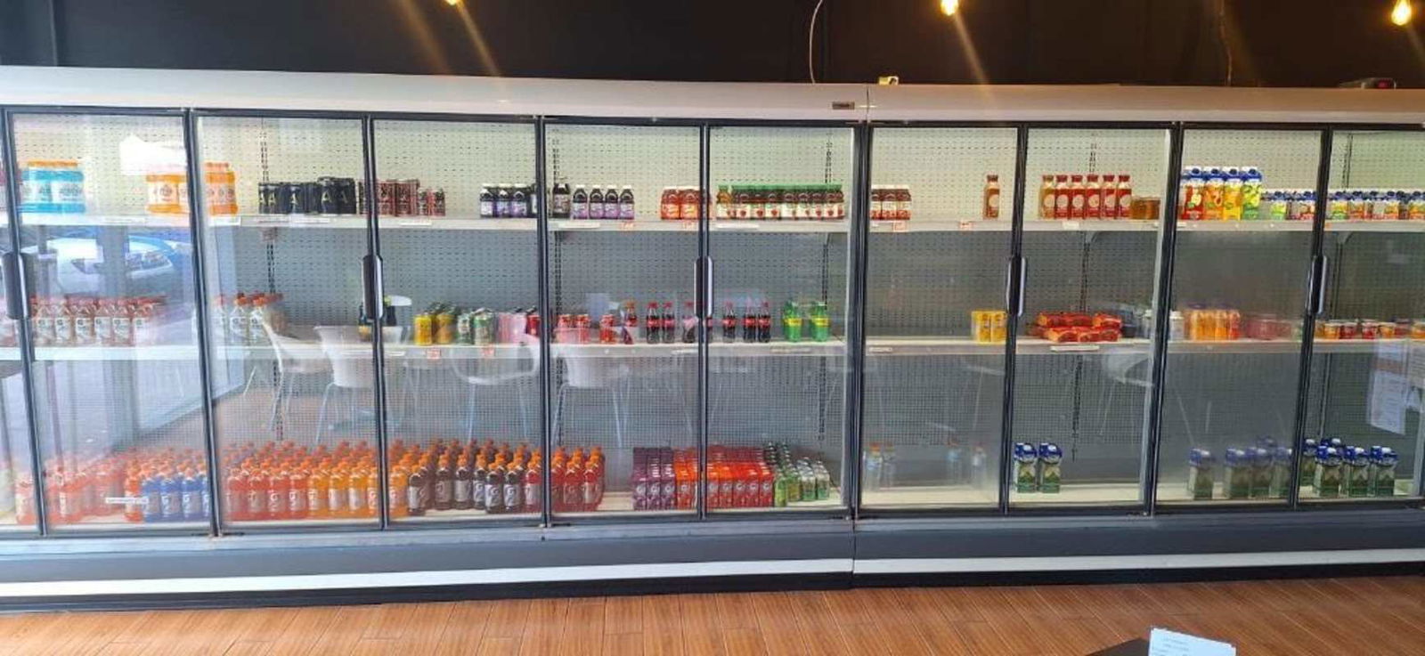 Retail shop cooled display cases with assorted beverage bottles Chepo area Panama