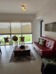 Large bedroom with walk-in closet, queen bed, garden views at PH Mosaic Panama Pacifico