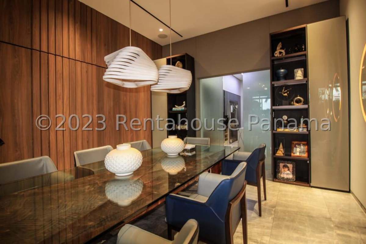 Modern dining room with glass table and panoramic ocean view windows in PH Ocean Two Punta Pacifica