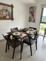 Modern kitchen with granite countertops, appliances, and cabinetry in PH Mosaic Panama Pacifico