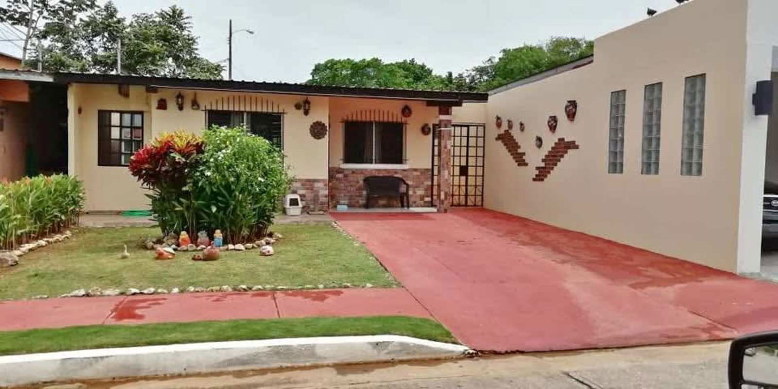 Single-level house front driveway garden brick accents Las Praderas Panama City