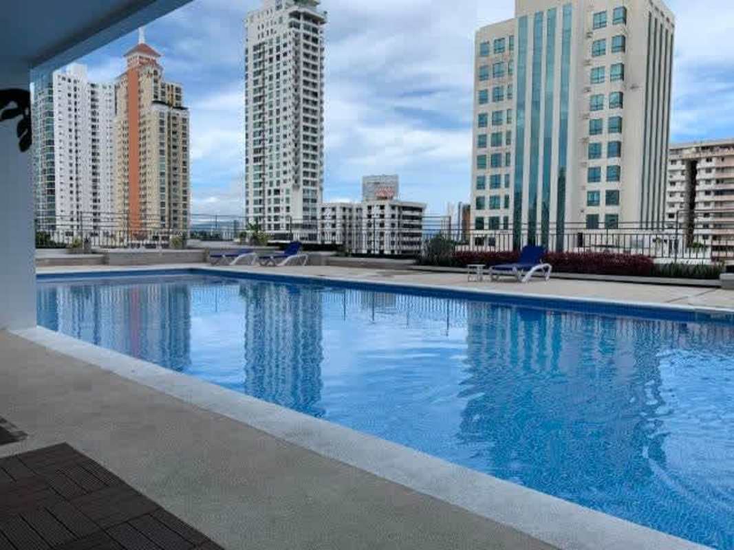 Open living room and kitchen with large windows overlooking Panama City in PH Premium Tower
