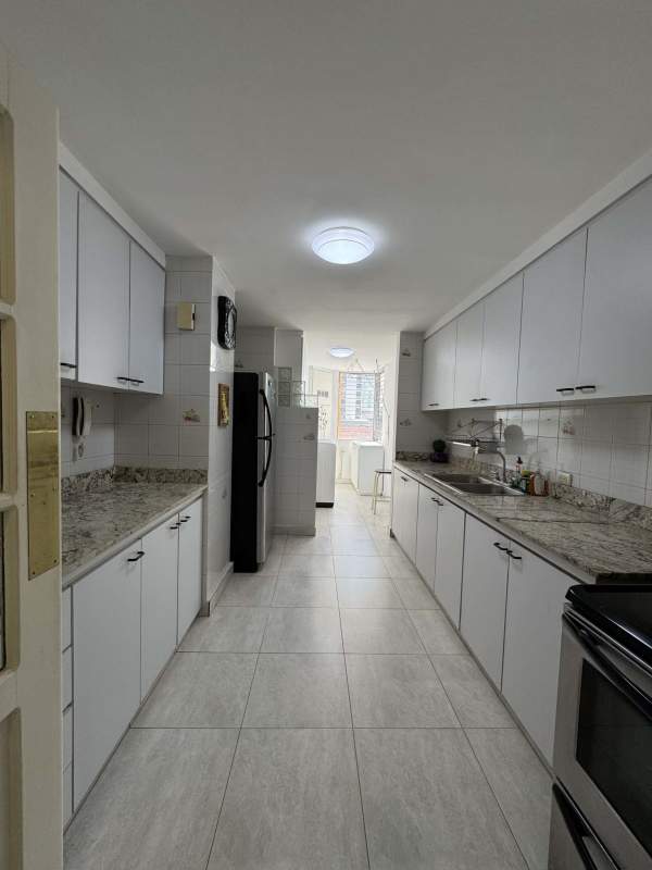 Traditional entry hallway with ornate mirror console and vintage decor in Marbella apartment Panama City