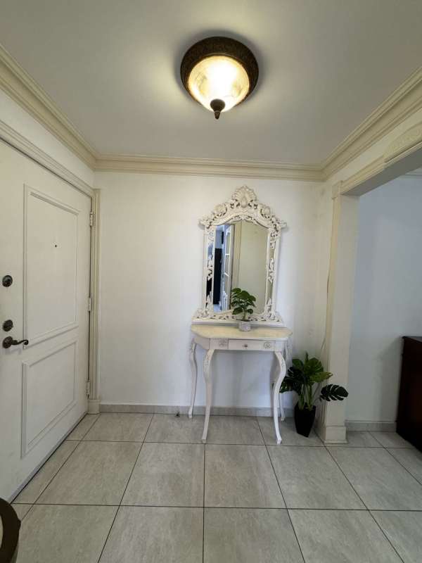 Modern minimalist bedroom with wardrobe, TV, AC and work area Marbella rental apartment Panama City 