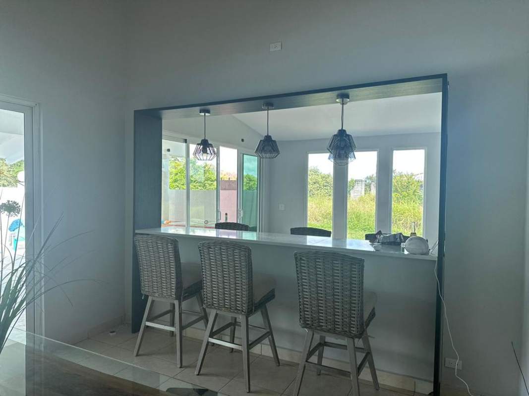 Kitchen with gas stove, stainless refrigerator, tile finishes at Malibu Playa Gorgona