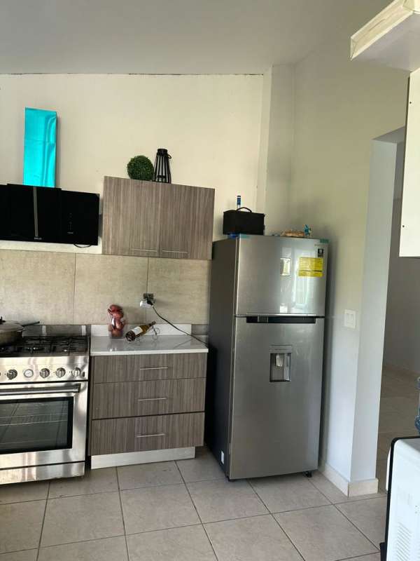 Breakfast bar with wicker stools, modern pendant lights in beach vacation house Gorgona Panama