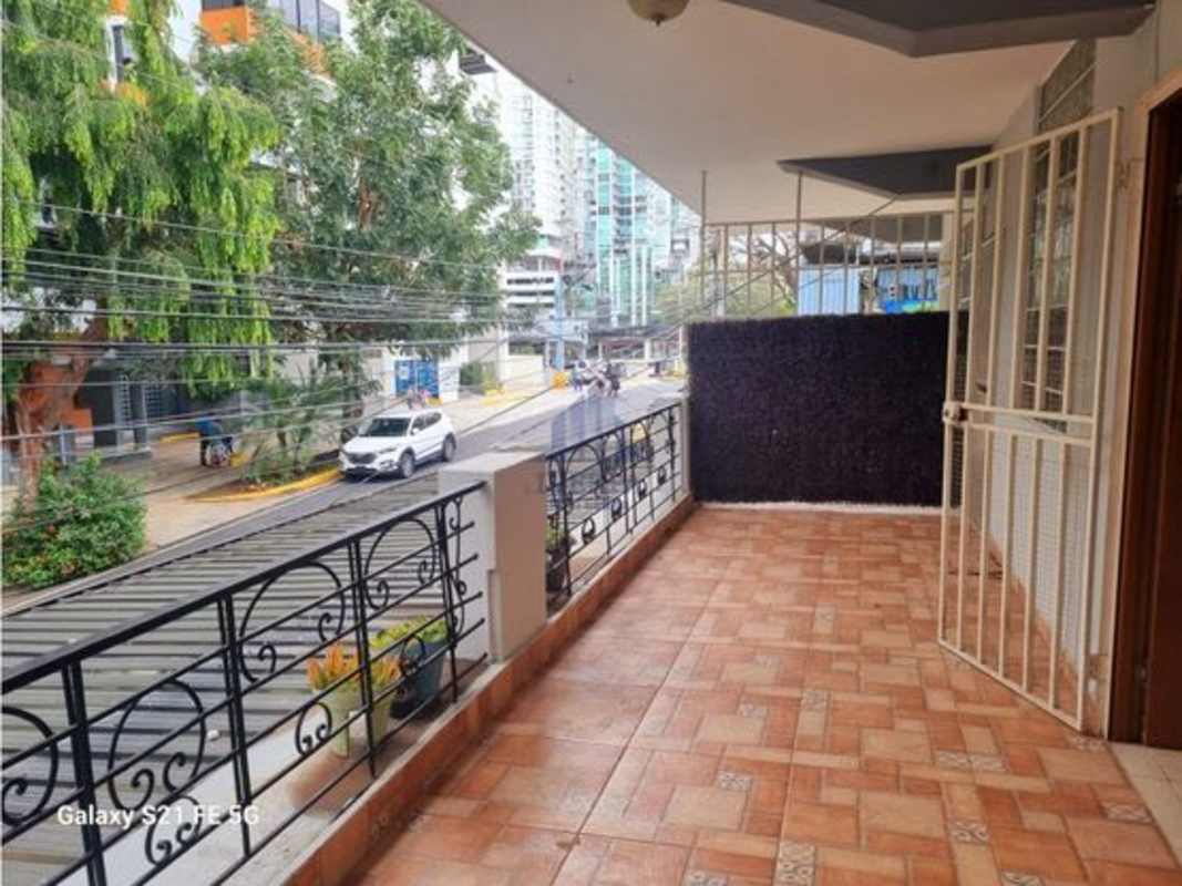 Apartment balcony with ceramic tile floor, railing and skyline views Panama City