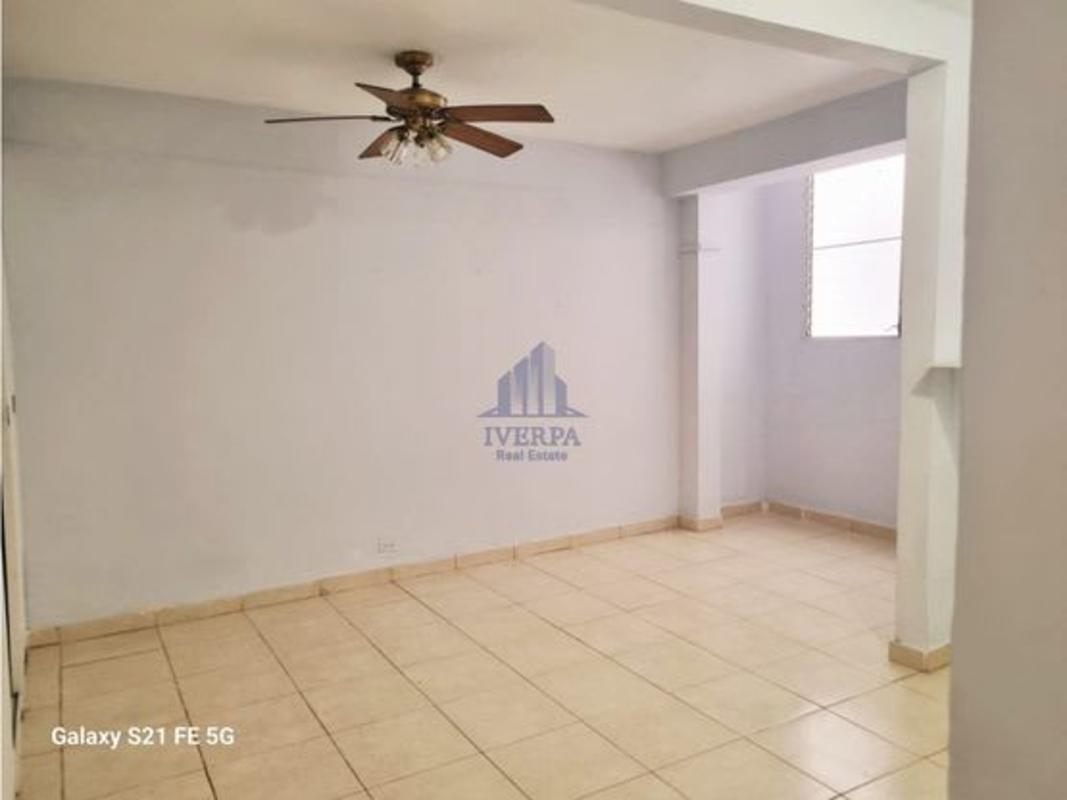 Kitchen with large window, tile backsplash, fan and breakfast bar in PH San Francisco Place Panama