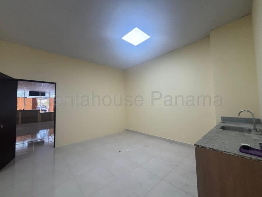 Small kitchenette inside commercial space with granite top, sink, skylight Panama City
