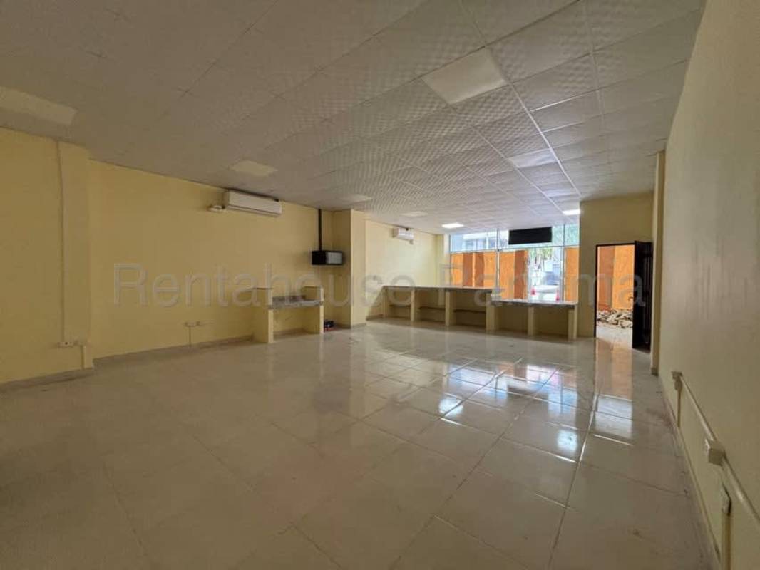 Spacious empty retail or office interior with tiled floors, counters, glass entrance Panama City