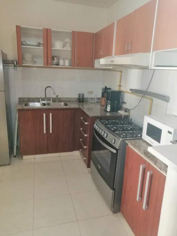Kitchen with granite countertop, gas stove, cabinets in Brisas del Golf Panama