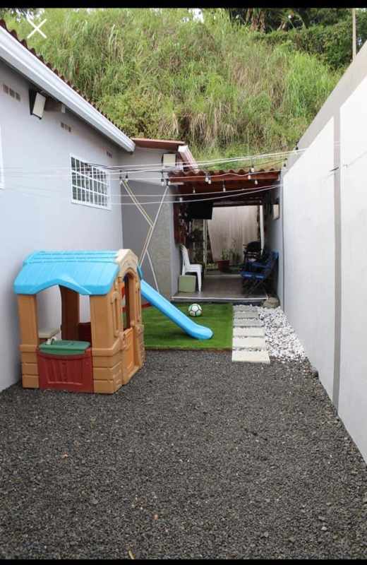 Private backyard with playhouse, slide, artificial grass and patio area in Brisas del Golf Urbanization Panama