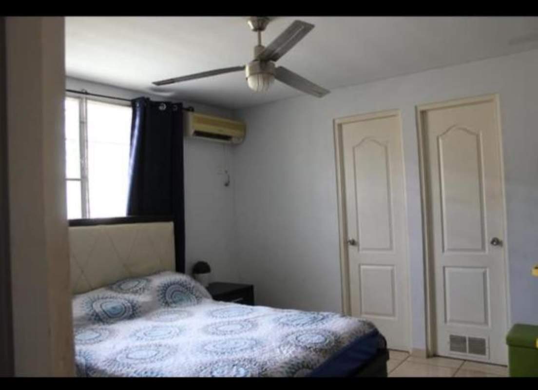 Bright bedroom with closet, ceiling fan, window AC and blackout curtains in Brisas del Golf Panama