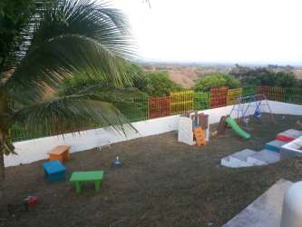 Fully equipped rustic style kitchen granite countertops wooden cabinets in Las Uvas house rental Panama