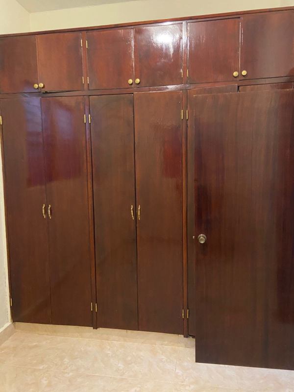 Bedroom with built-in closet and tiled flooring at PH Parque Lefevre Panama