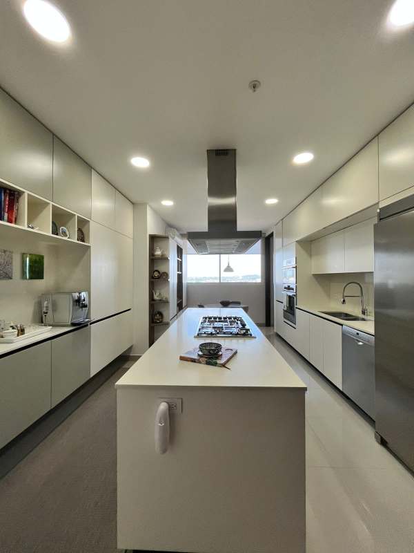 Gourmet kitchen with island, modern cabinets, stainless appliances and window golf view at PH Solana Santa Maria