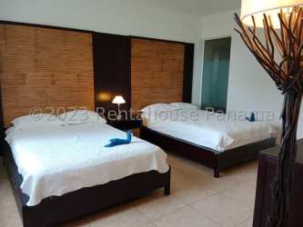 Modern bathroom with marble tiles, double sink vanity, glass shower in Playa Blanca Nikki Beach condo Panama