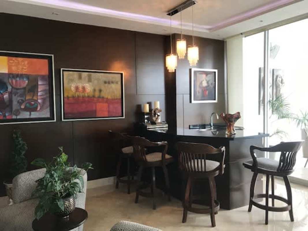 Contemporary kitchen with granite countertops, large island and stainless appliances at The Point Punta Paitilla