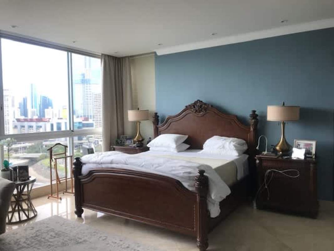 Luxury bedroom suite with large windows and ocean views at The Point Punta Paitilla