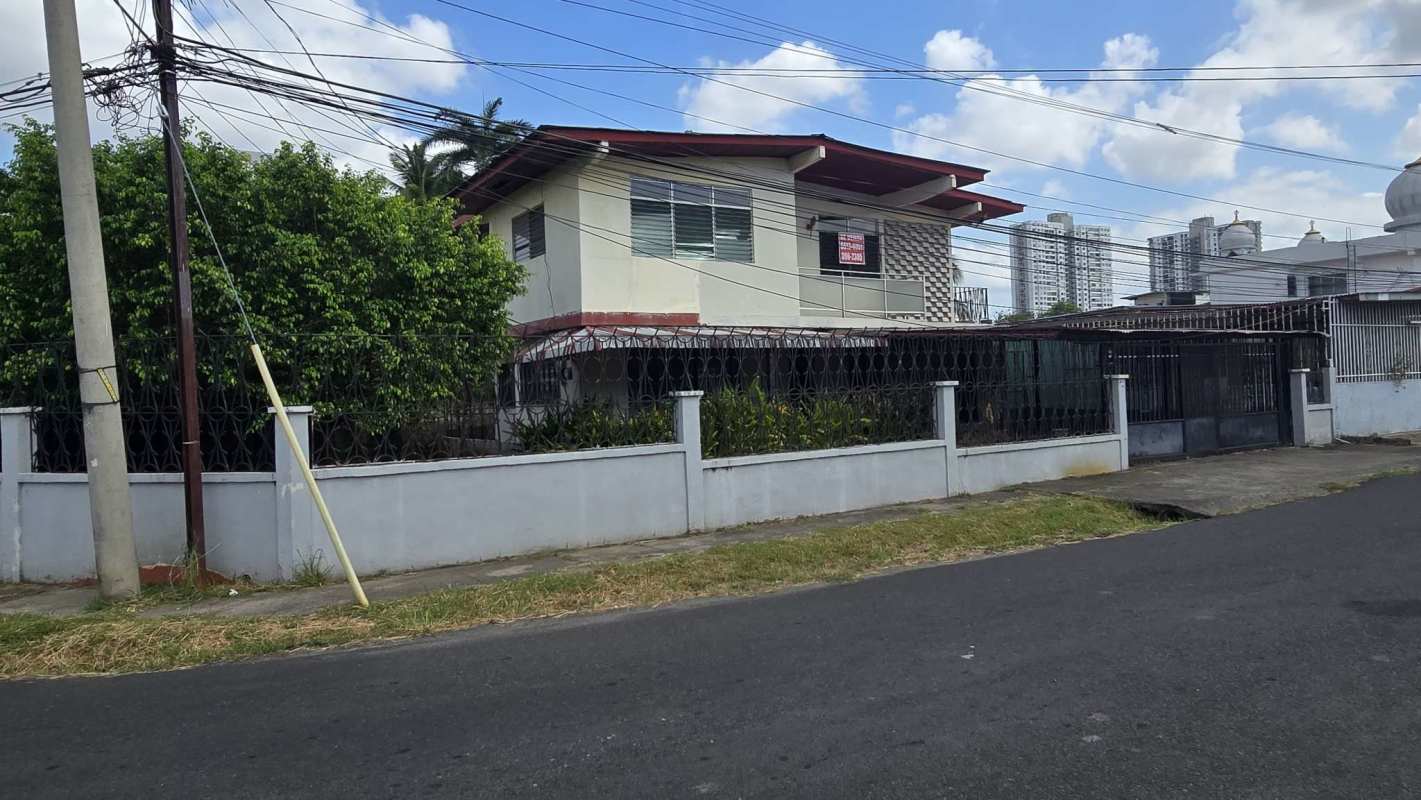 Gated facade with garage and balconies of a two-story house for sale in Panama City