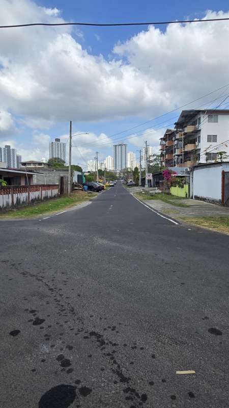Street with residential houses in Parque Lefevre Panama City skyline background