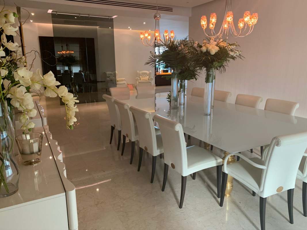Luxury dining area with modern chandelier, marble floors, large table in Venetian Tower Punta Pacífica