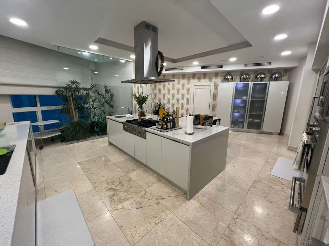 Contemporary kitchen with island, marble floors, Italian cabinets in Venetian Tower Punta Pacífica Panama
