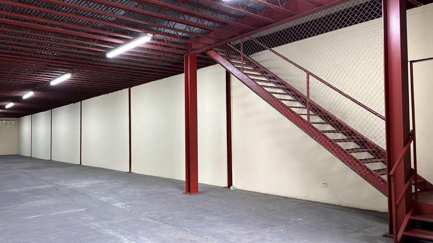 Warehouse interior with red metal staircase mezzanine access industrial space El Crisol Panama