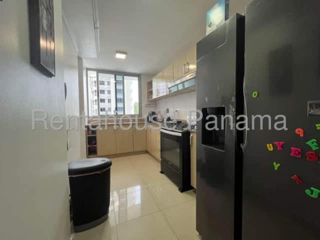Kitchen with large window, fridge, granite top at PH Rokas Condado del Rey Panama