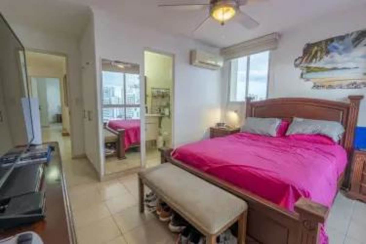 Ensuite master bedroom with large window, ceiling fan and city view at PH Mandalay Panama