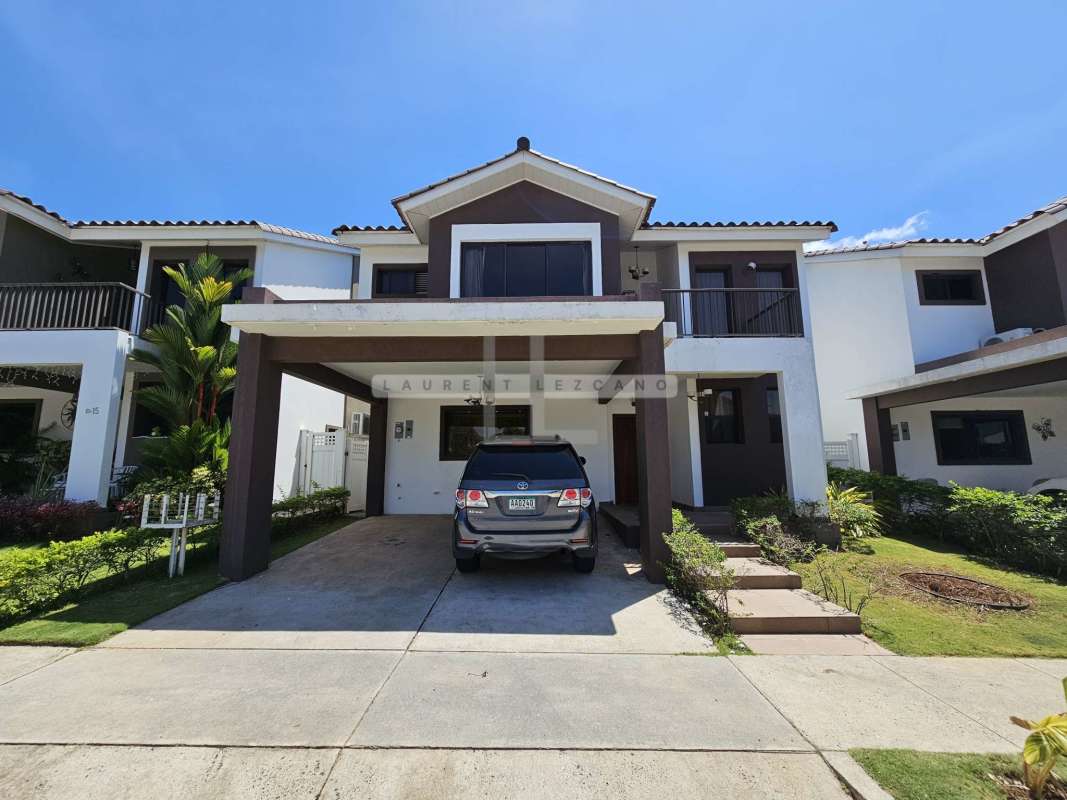 Modern detached home facade with driveway and balconies in Olympus gated community Panama