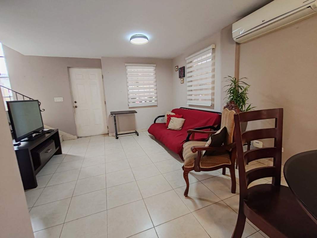 Remodeled modern kitchen with granite counters, appliances, tile backsplash in Condado del Rey townhome for rent