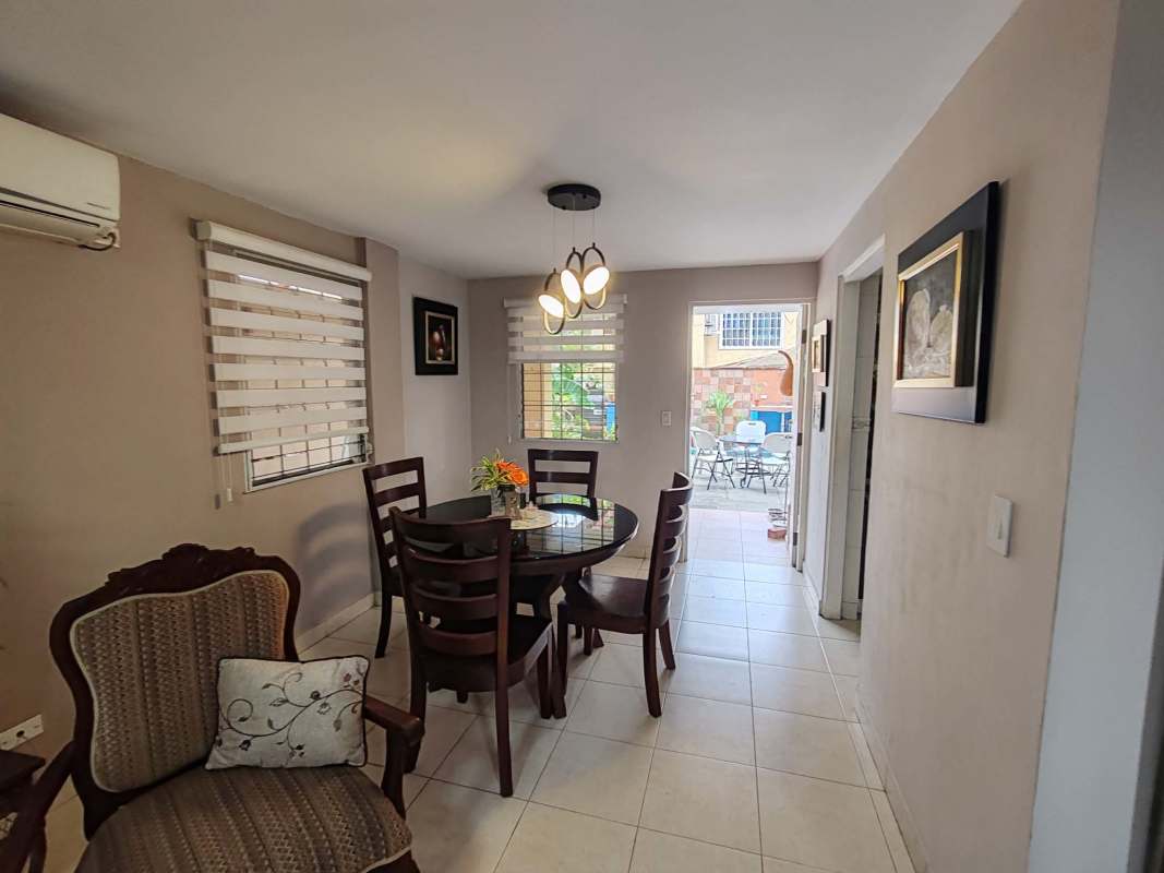 Dining room with large window view to patio, ceramic flooring in Condado del Rey townhouse