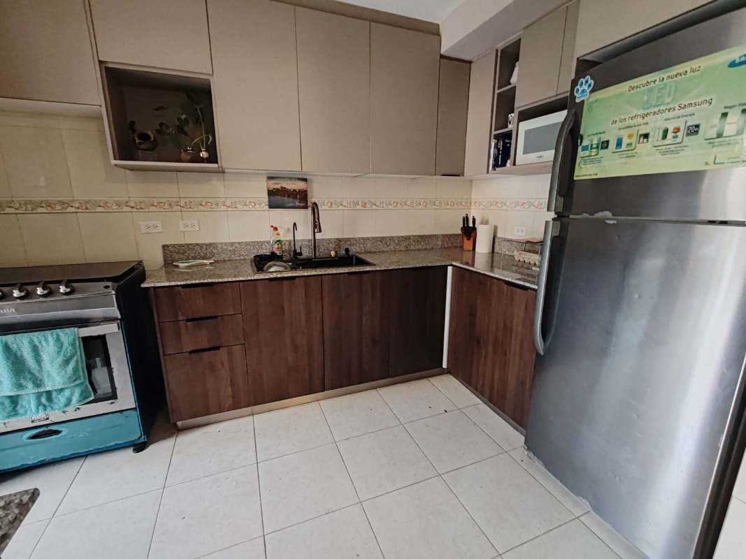 Close-up of kitchen with granite counters, fridge and gas stove in Condado del Rey rental home