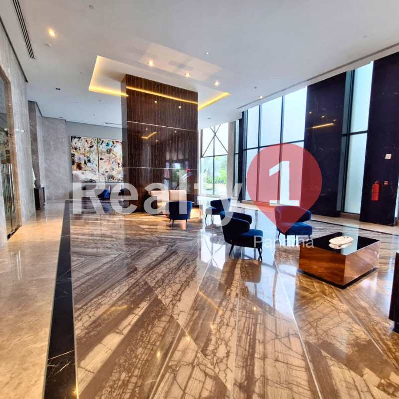 Spacious lobby with marble floors and tall windows in Empire Residences Santa María Panama