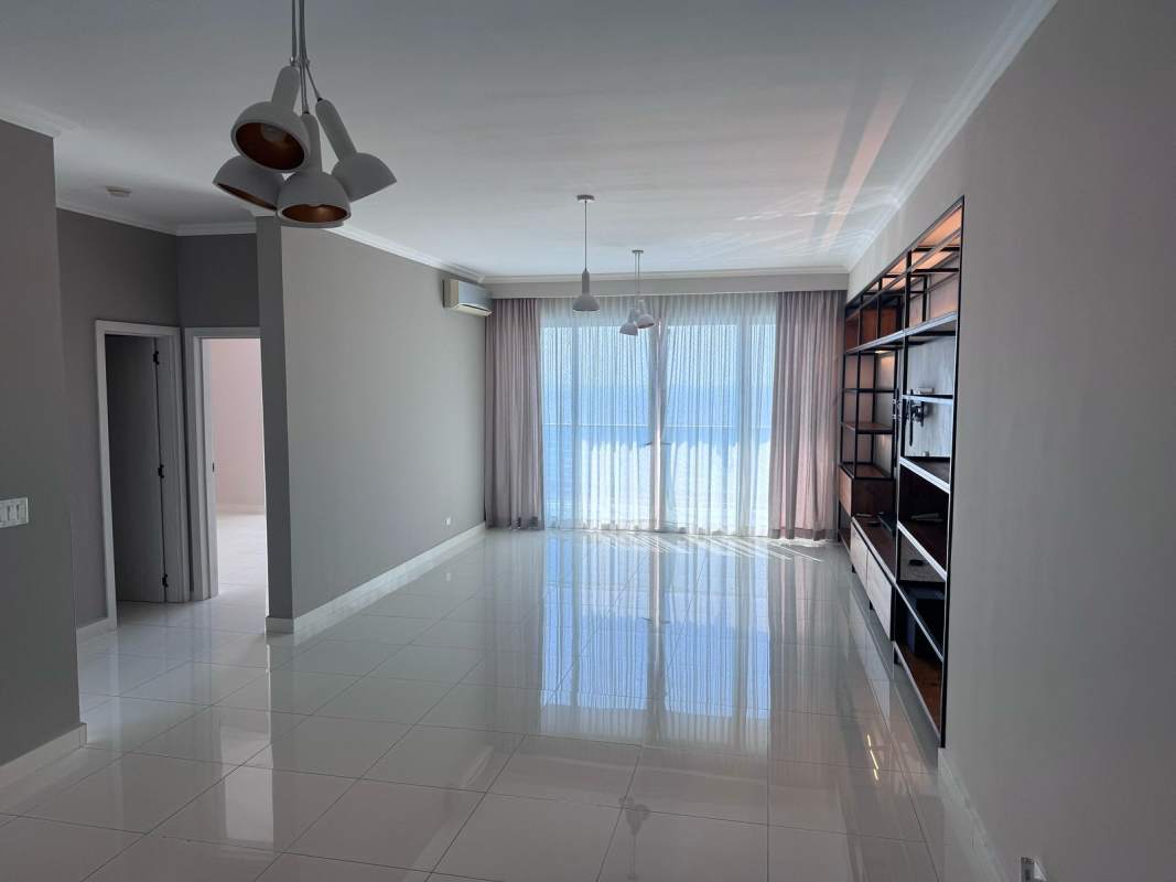 Large bright bedroom featuring partial ocean views, tile floors, and AC PH Nautica Panama