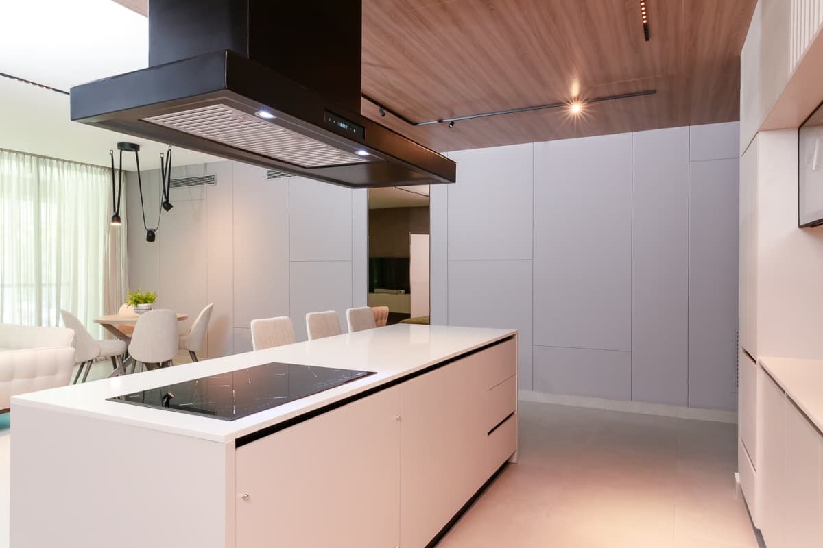 Modern white kitchen with island and induction cooktop Uptown Marbella Residences Panama City