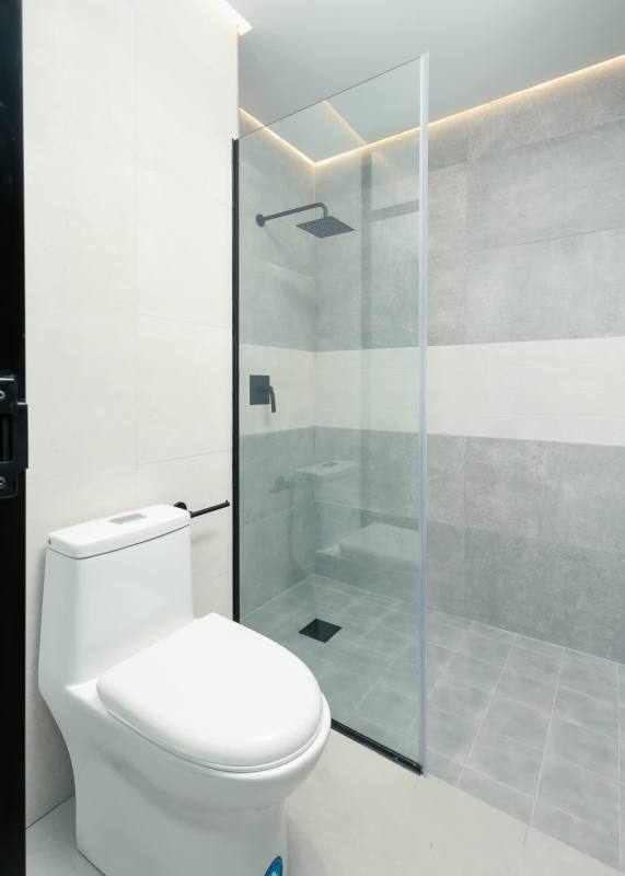 Minimalist glass-enclosed shower in new Uptown Marbella apartment Panama